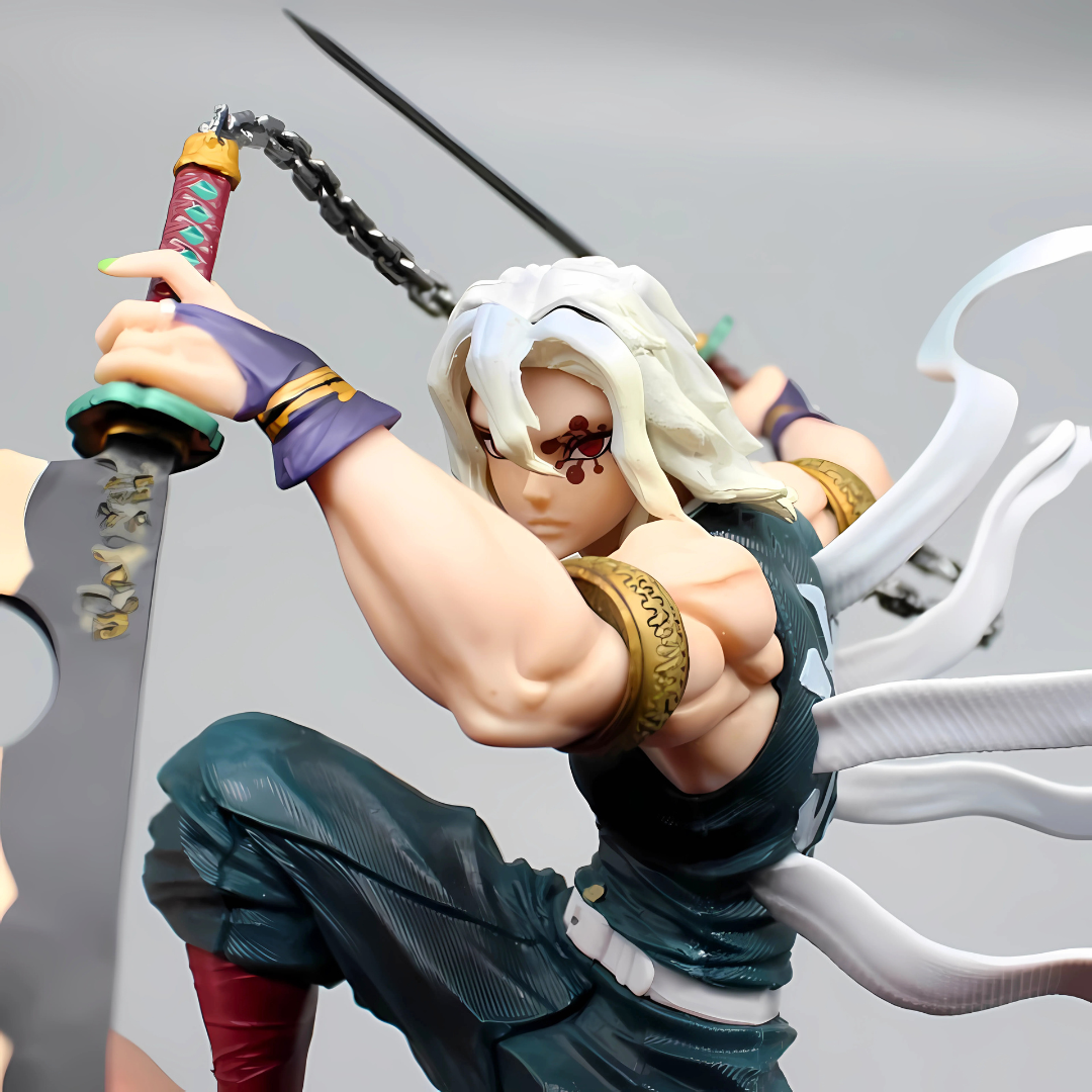 Figurine of a character with white hair and a sword, wearing a green outfit with gold accents.
