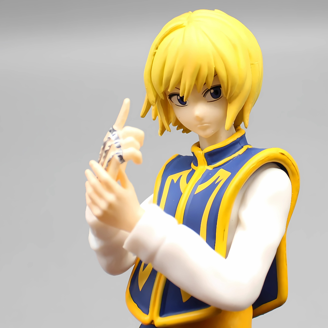 Figurine of a character with yellow hair and blue and yellow outfit on a gray background