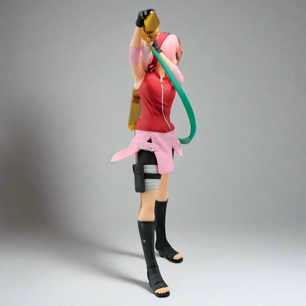 Action figure with pink outfit and black boots on a gray background