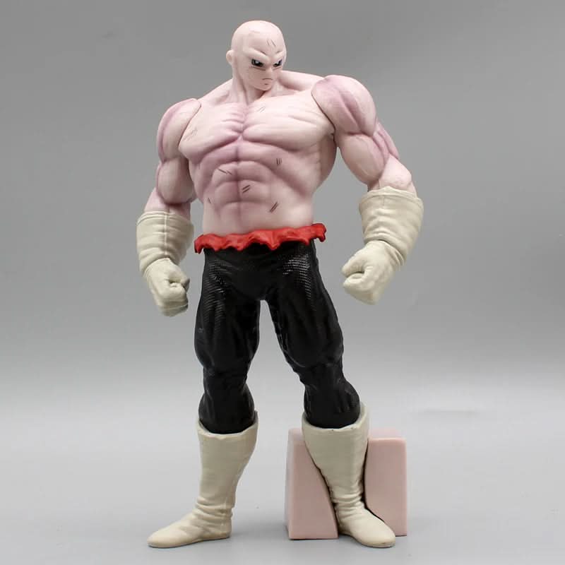 Full front view of a Jiren figure from Dragon Ball standing with arms down beside a small beige block.