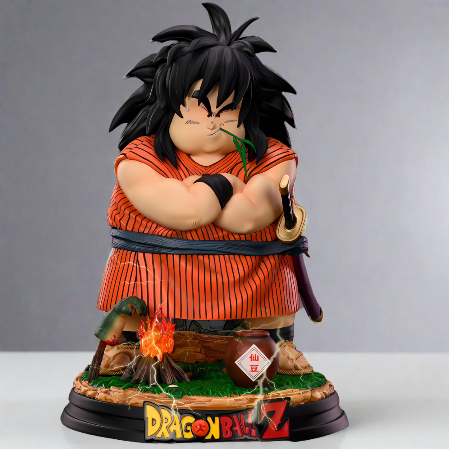 Collectible figure of Yajirobe from Dragon Ball Z, with arms crossed and a sly expression, perched on a base with the show's logo. The figure is presented in front of a comic book-style illustration with action effects.