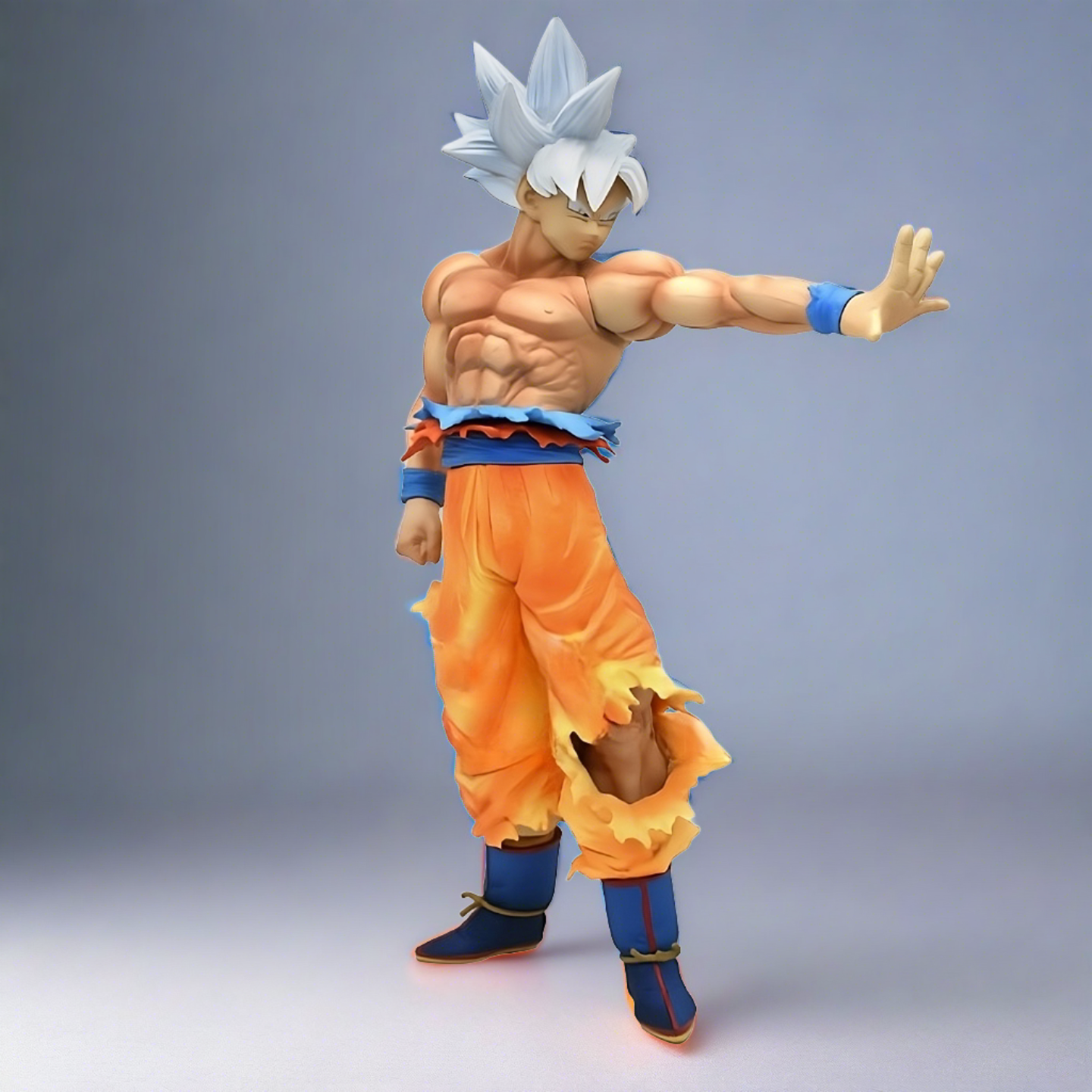 Dragon Ball collectible of Goku in Ultra Instinct form, side stance with a focused expression, and detailed muscle structure, set against a white background.