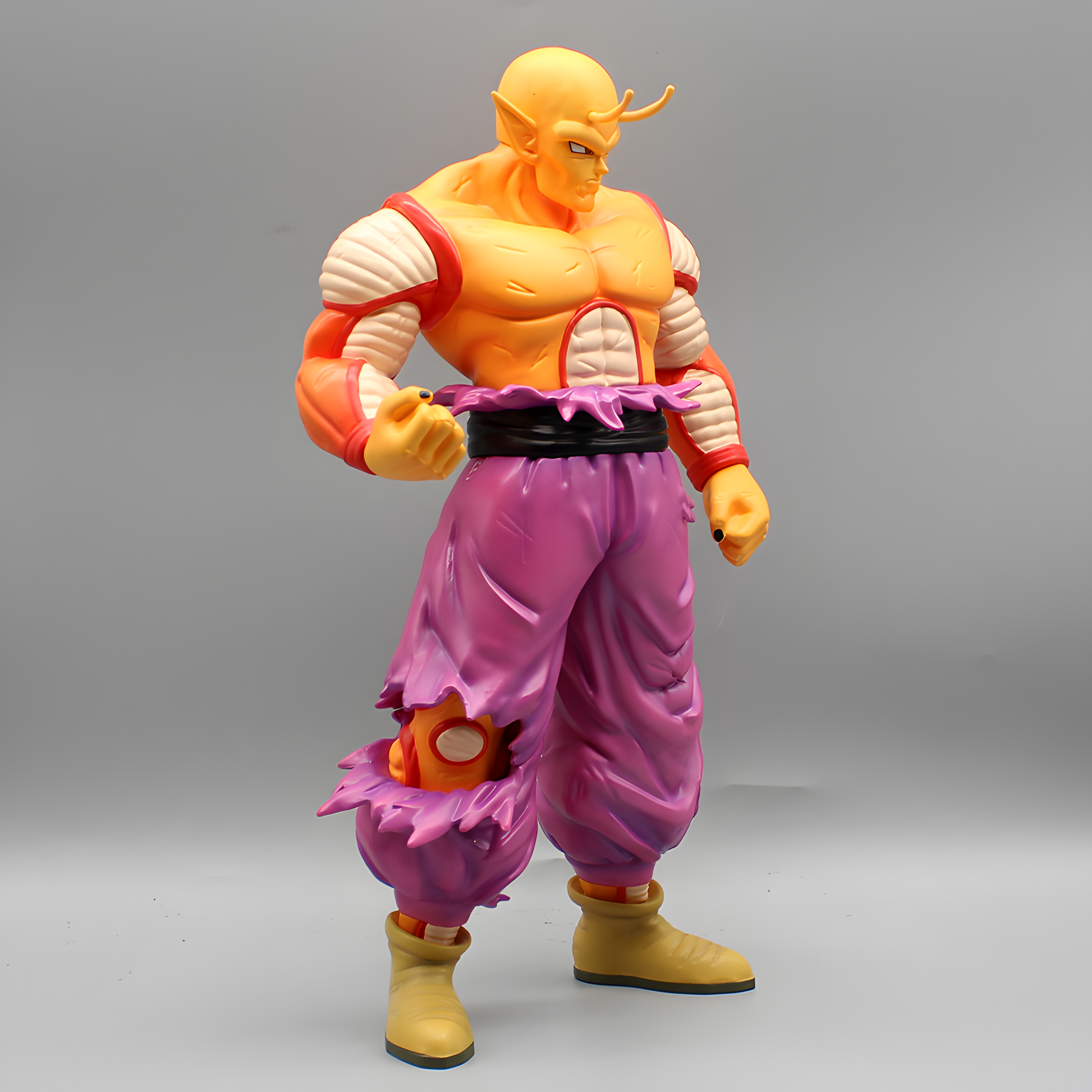 Dynamic angle of Piccolo Dragon Ball collectible showcasing his muscular build and iconic outfit, with a focus on the textured details of his purple pants.