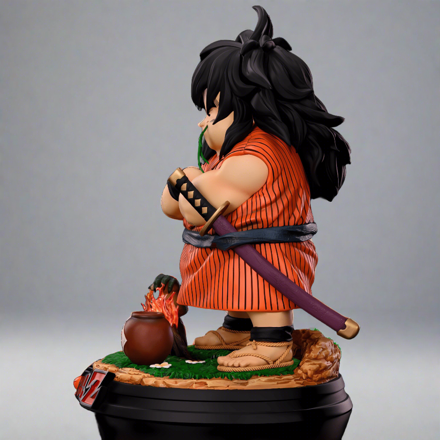 Side view of a Dragon Ball Z Yajirobe collectible figure, with arms crossed and a katana sheathed at his back. Details include his rugged boots and a small fire with a pot on the base, set against a black background.