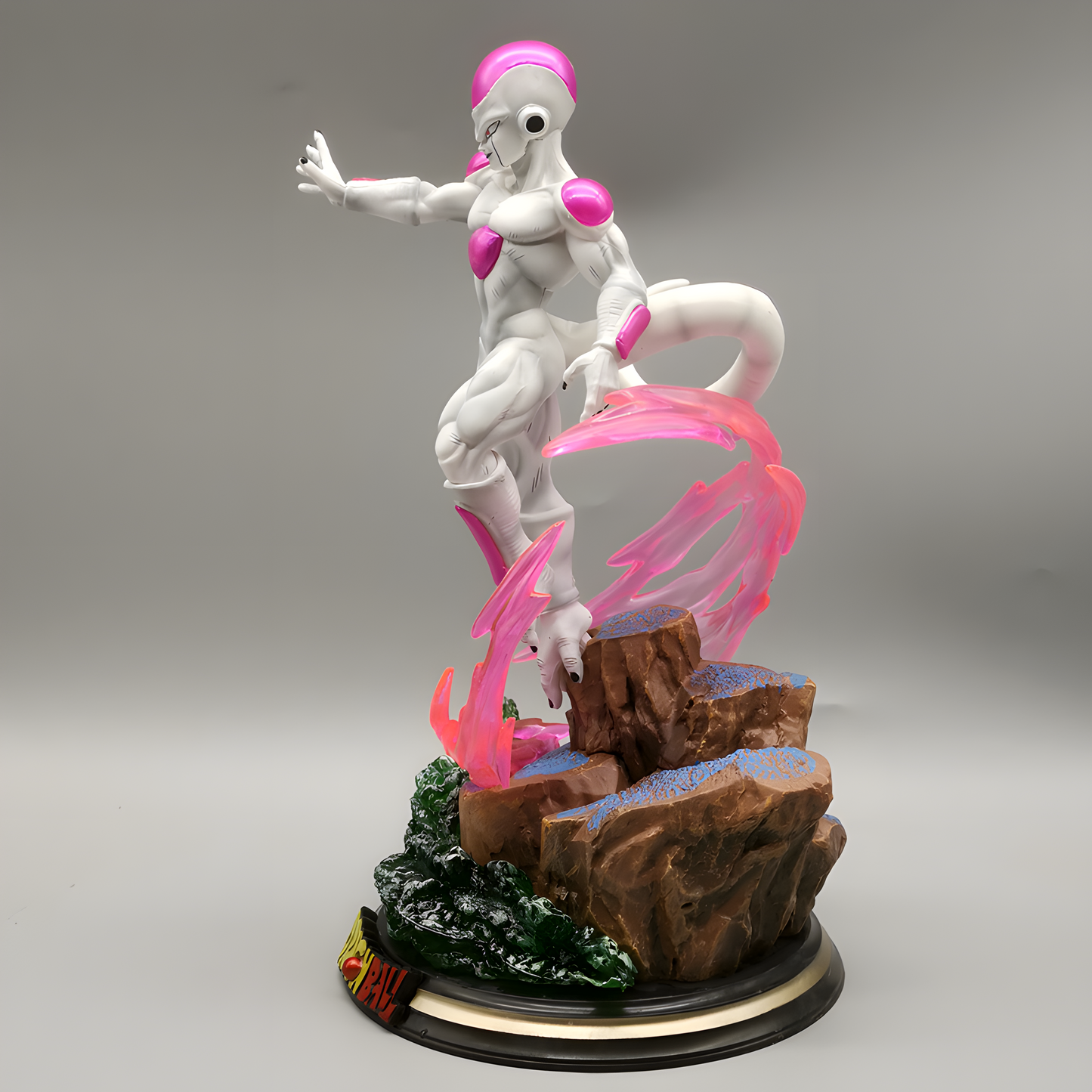 Frieza collectible statue captured mid-motion, with intense eyes and a raised hand ready to unleash power, surrounded by vivid pink energy effects.
