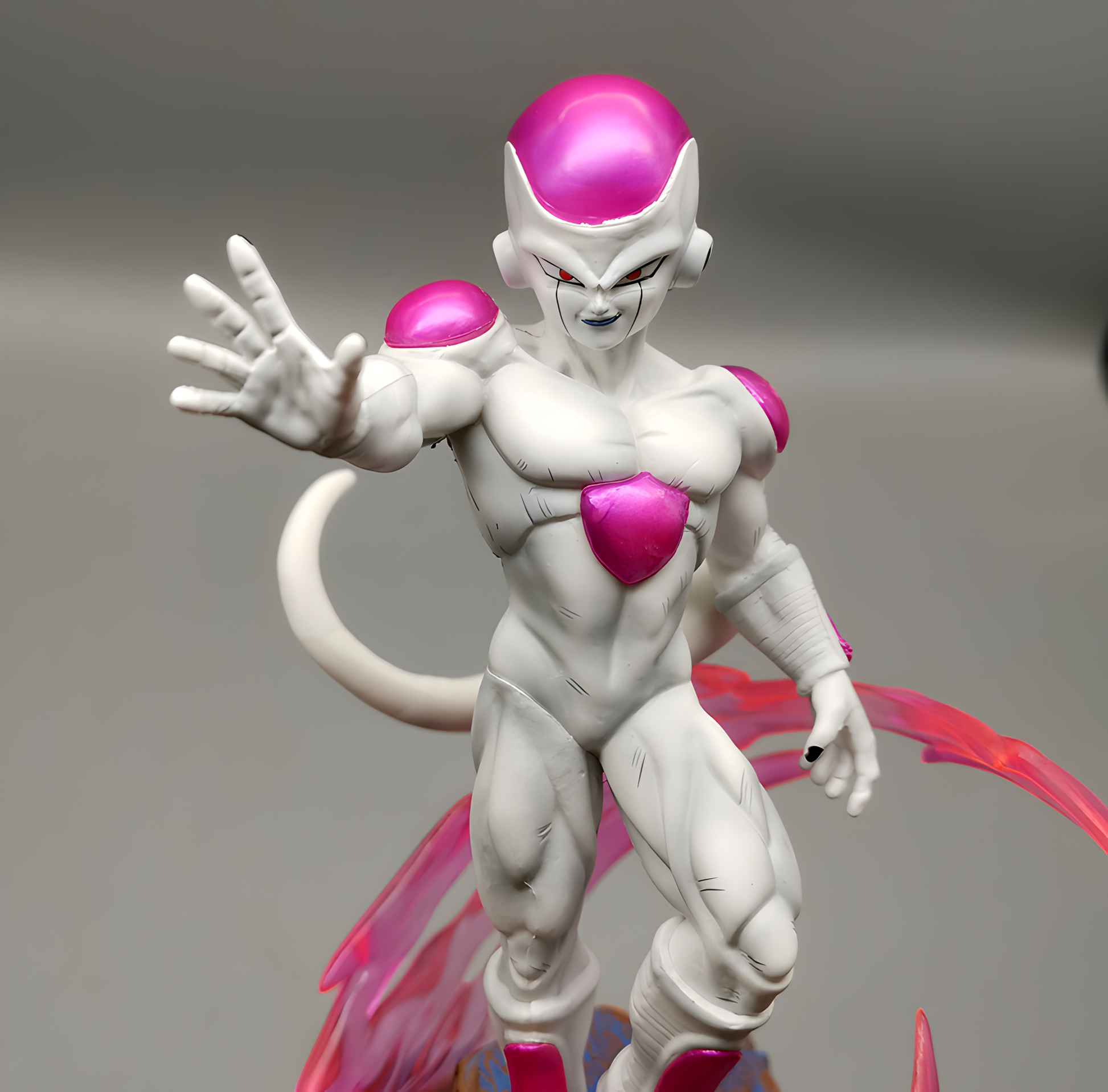 Close-up of the detailed Frieza action figure from Dragon Ball Z, emphasizing his imposing stare and the pink accents of his supernatural energy.