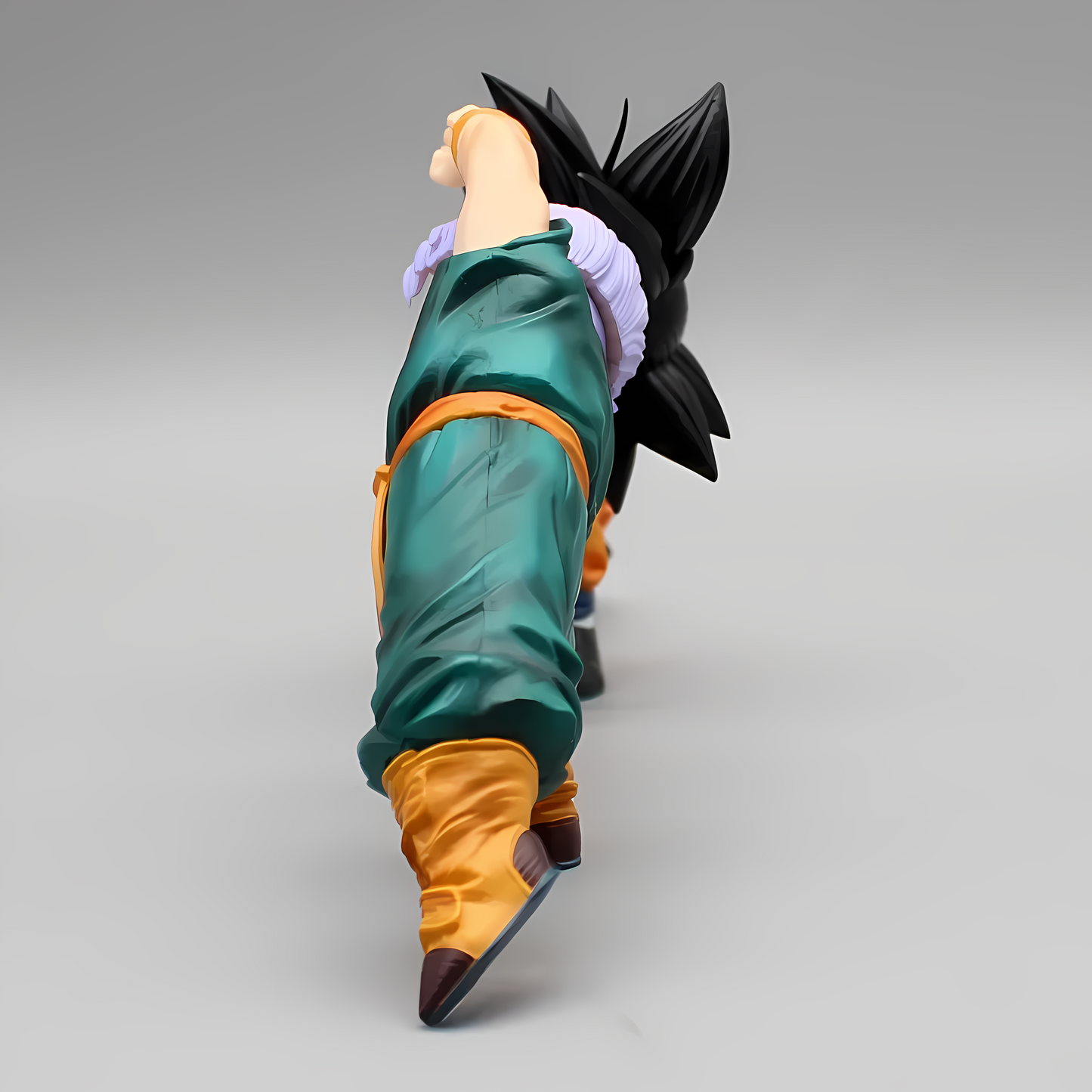 Synchronized Goten and Trunks figures captured in a static moment of the fusion dance on a neutral backdrop, showcasing the figures' detailed design and the characters' concentration.