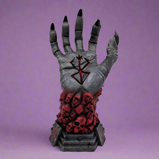 Decorative hand with black nails, red interior, and skull design on a white background