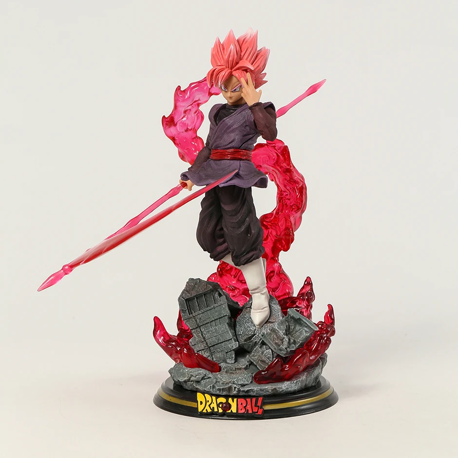 The Black Goku Rises collectible from Dragon Ball features a detailed figure of Goku Black in his Super Saiyan Rose form, complete with a glowing pink energy sword and dynamic flame-like energy aura. His focused expression and battle-ready pose are set atop a ruined base with the DRAGON BALL logo, and the statue is illuminated with built-in lights that cast a dramatic glow.