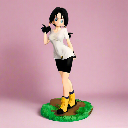 Figurine of a character with black hair, white shirt, and yellow boots on a pink background