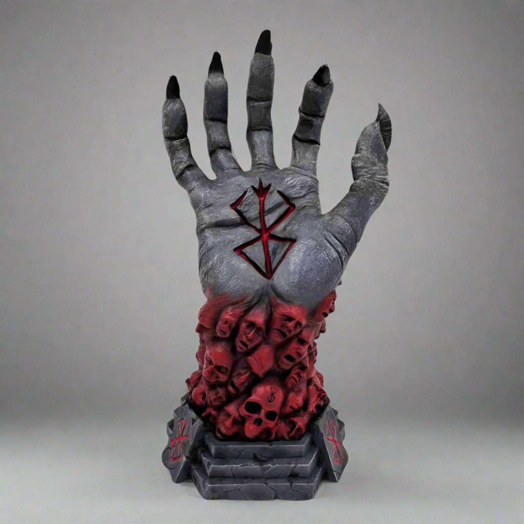 Decorative hand with red skull design and black nails on a white background