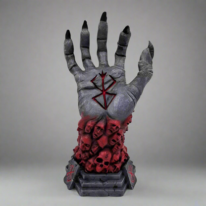 Decorative hand with red skull design and black nails on a white background