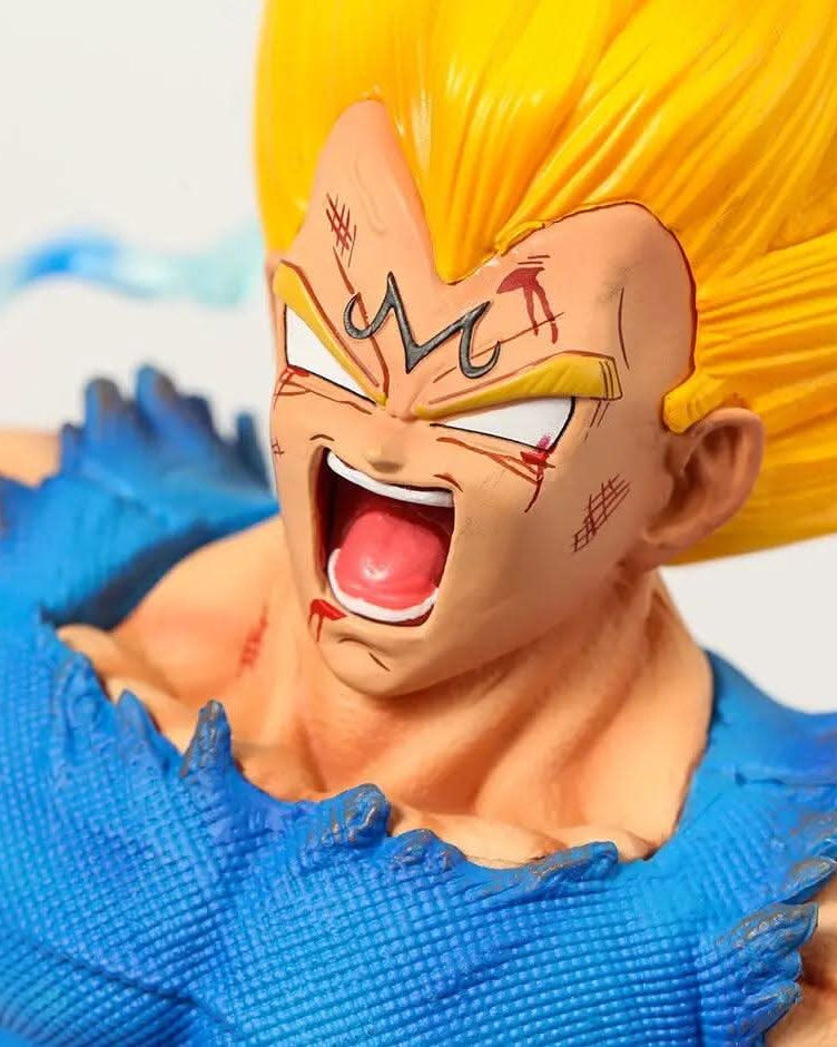 Close-up of a Majin Vegeta figurine from Dragon Ball Z, featuring a detailed facial expression full of intensity and rage, with vivid Super Saiyan yellow hair and the character's iconic M symbol on his forehead, set against a soft-focus background.