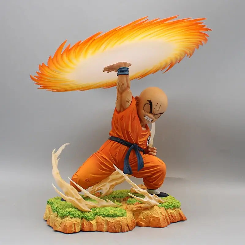 Dragon Ball anime PVC statue of Krillin in a poised stance, channeling his energy into the iconic flaming Destructo Disc above his head, against a neutral background that accentuates the vivid colors and dynamic motion of the figurine.