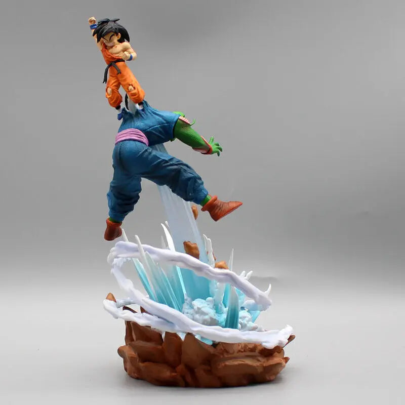 Dynamic figurine of Goku from Dragon Ball, captured mid-flight with a focused expression, emerging from an energetic burst of blue-white energy on a rugged brown base, against a neutral gray background.