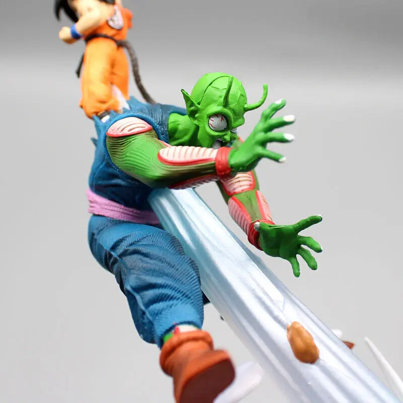 Close-up on a Dragon Ball figurine showing Piccolo in a defensive posture, with a detailed expression of intensity, as he clashes with Goku who is partially visible in the background.