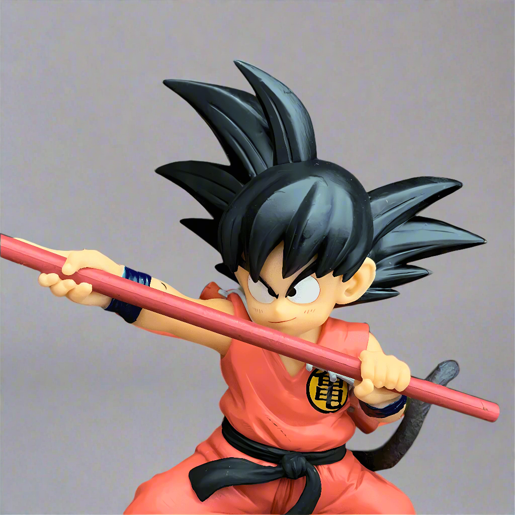 Intense Dragon Ball figure of 'The Adventures Begin' Goku, gripping his Power Pole ready for action, set before an explosive orange backdrop, a must-have for collectors.