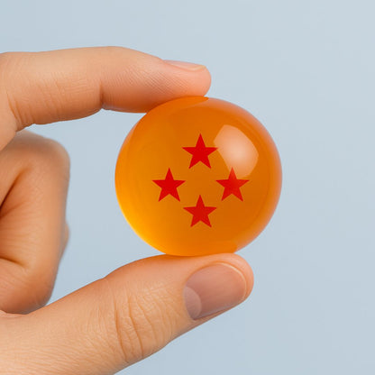 Three-star Dragon Ball replica held between fingers – compact collectible from Dragon Ball series.